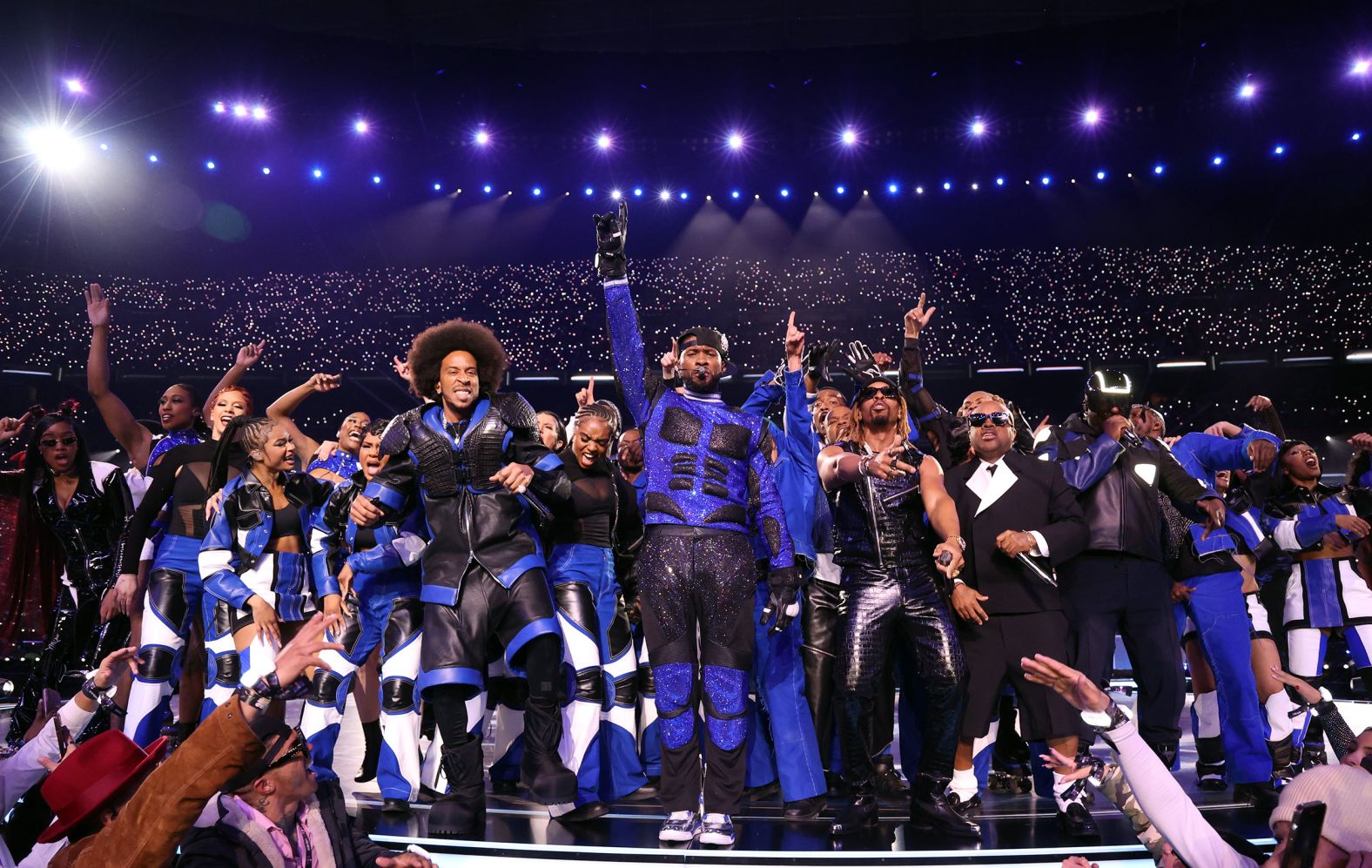 Usher, center, and his fellow performers close out the Super Bowl halftime show on Sunday, February 11. The game was held at Allegiant Stadium, just off the Las Vegas Strip.