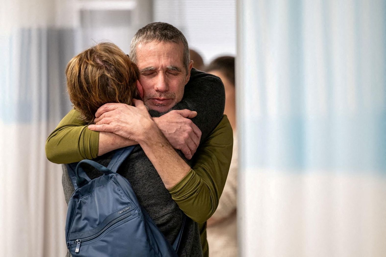 Fernando Simon Marman hugs a loved one in Ramat Gan, Israel, on Monday, February 12, after he and another hostage were rescued in an Israeli military raid in Rafah, Gaza. Marman, 60, and Louis Har, 70, were both taken during Hamas' October 7 attack on Israel. After the rescue, the total number of hostages left in Gaza was 134, according to Israel Defense Forces spokesperson Daniel Hagari.