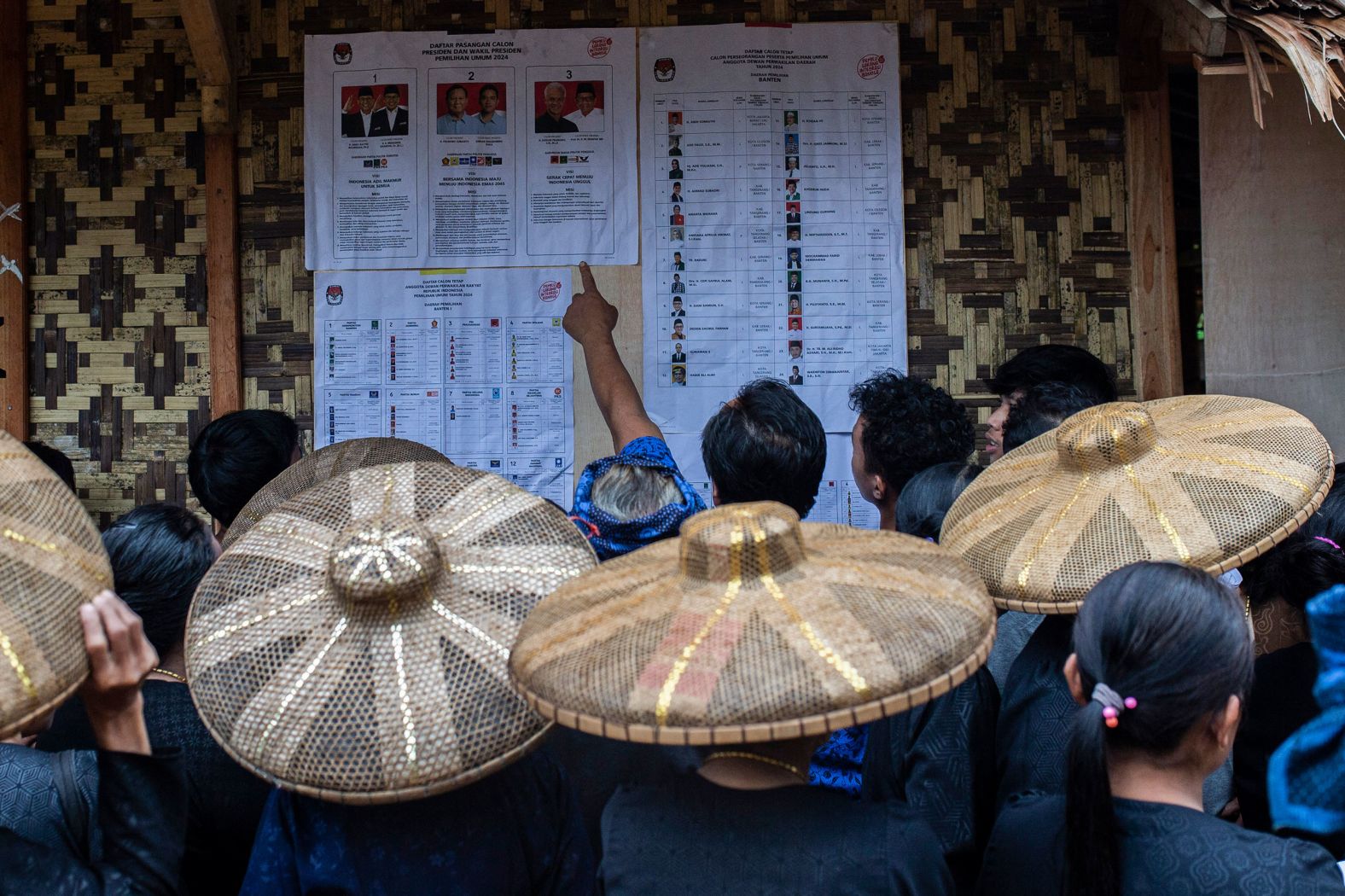 Members of the indigenous Baduy tribe check the candidates list in the Indonesian village of Kanekes before casting their ballot during Indonesia's presidential and legislative elections on Wednesday, February 14.