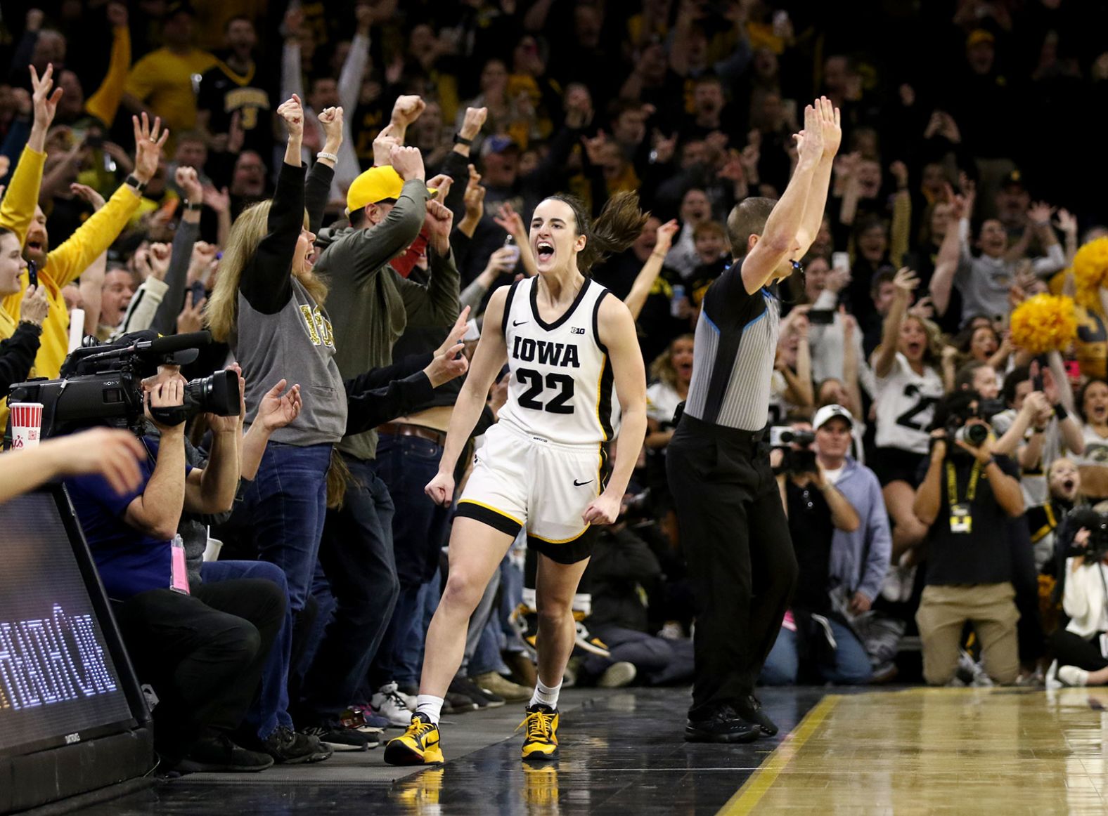 Iowa star Caitlin Clark celebrates after she hit a 3-pointer against Michigan to become the all-time leading scorer in NCAA women's basketball on Thursday, February 15. Clark surpassed the previous record of 3,527 career points, which was set by Kelsey Plum.