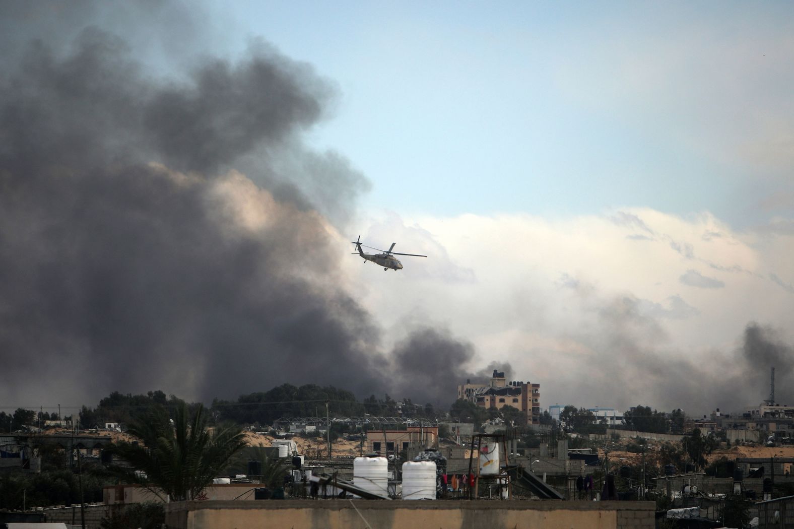 An Israeli helicopter flies over Khan Younis, Gaza, on Thursday, February 15. The besieged city in southern Gaza is the hometown of Hamas' leader in Gaza, Yahya Sinwar, and according to the Israel Defense Forces it is a major Hamas stronghold.