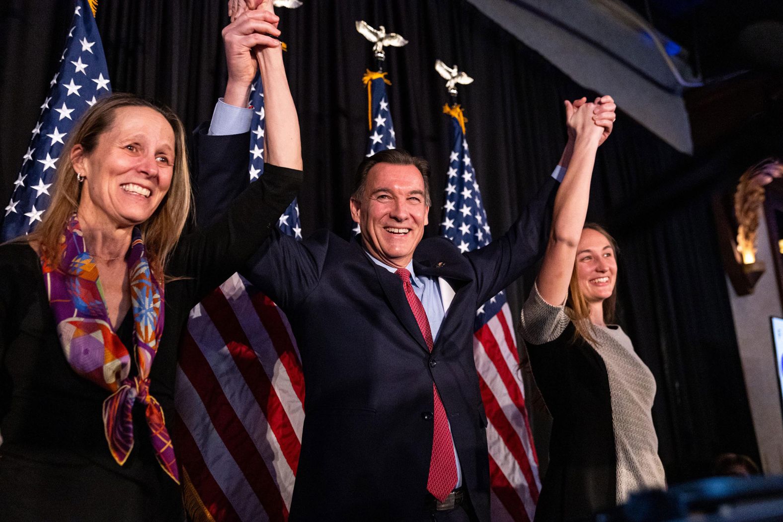 Former US Rep. Tom Suozzi appears with his wife, Helene, and his daughter, Caroline, at an election night party in Woodbury, New York, on Tuesday, February 13. Suozzi, a Democrat, won the special election to replace disgraced Republican George Santos in the House of Representatives. The result will further shrink the House GOP's narrow majority.