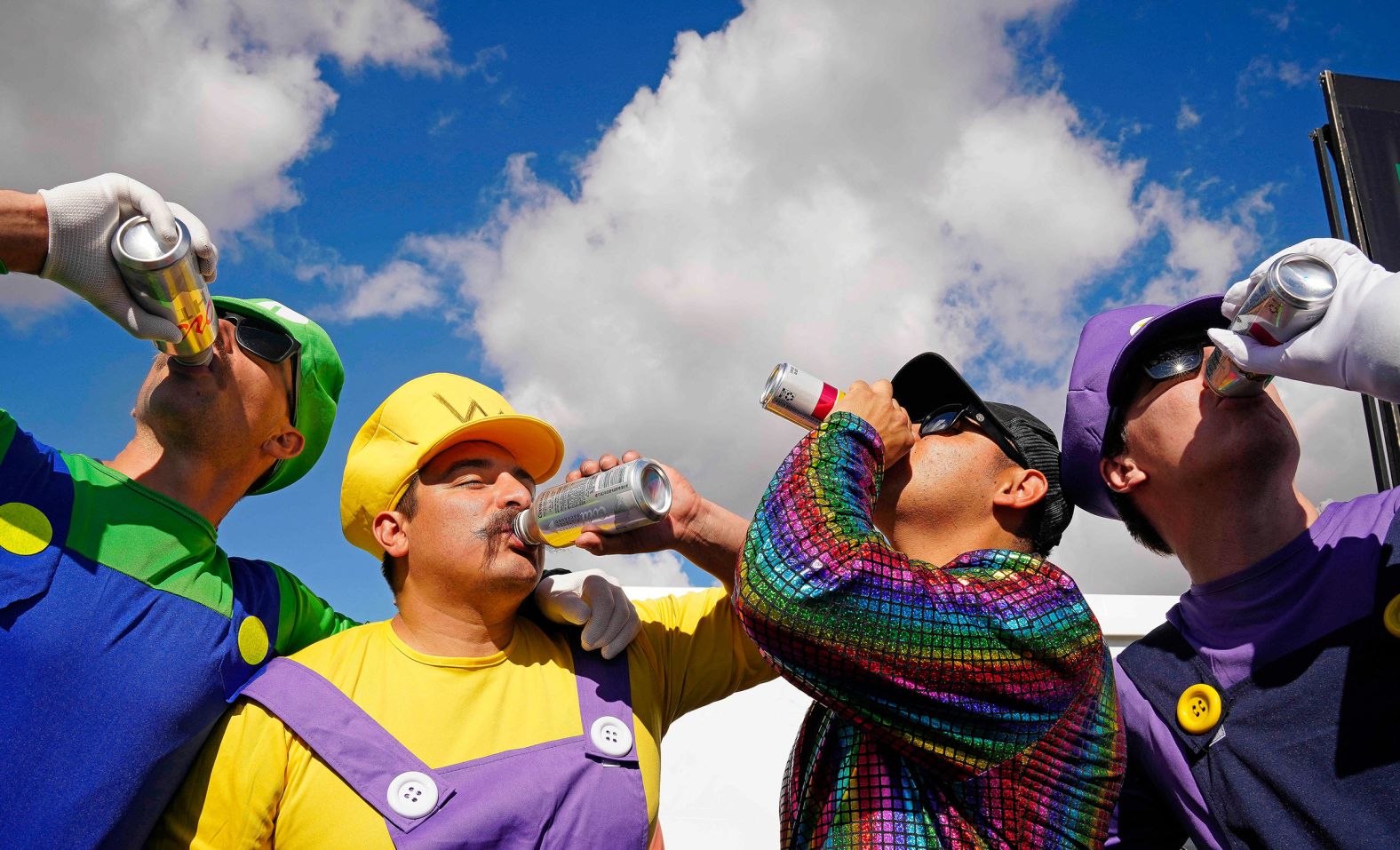 Costumed golf fans — from left, Grant Collinson, Cody Zavala, Juan Ruiz and Brett Beehler — drink beers while attending the WM Phoenix Open on Saturday, February 10. The tournament is renowned for its raucous atmosphere, but there were various crowd-related incidents this week that included arrests, fights and clashes between golfers and fans.
