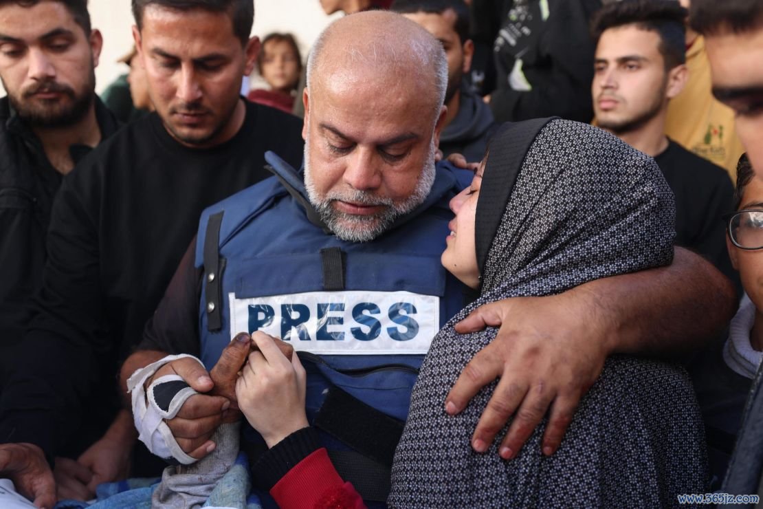 Al Jazeera's bureau chief in Gaza, Wael Al-Dahdouh (C) hugs his daughter during the funeral of his son Hamza Wael Dahdouh, a journalist with the Al Jazeera television network, who was killed in a reported Israeli air strike in Rafah in the Gaza Strip on January 7, 2024.