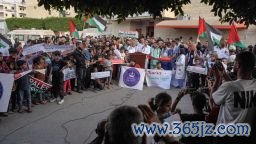 Members of a hospital's medical staff join a rally to thank pro-Palestinian student solidarity initiatives in US and Canadian universities on their campuses, in Deir el-Balah in the central Gaza Strip on May 1, 2024.